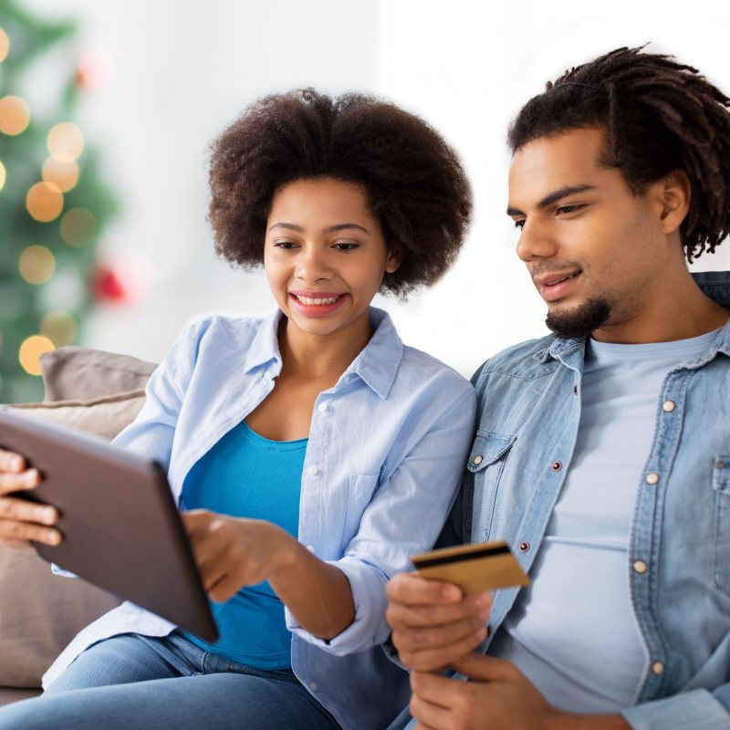 Couple Christmas Shopping on Couch